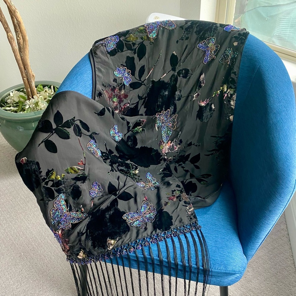 Beaded butterfly design shawl decorated with fringe edges.